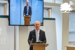 Tim Oliver delivering his speech to a full meeting of Surrey County Council